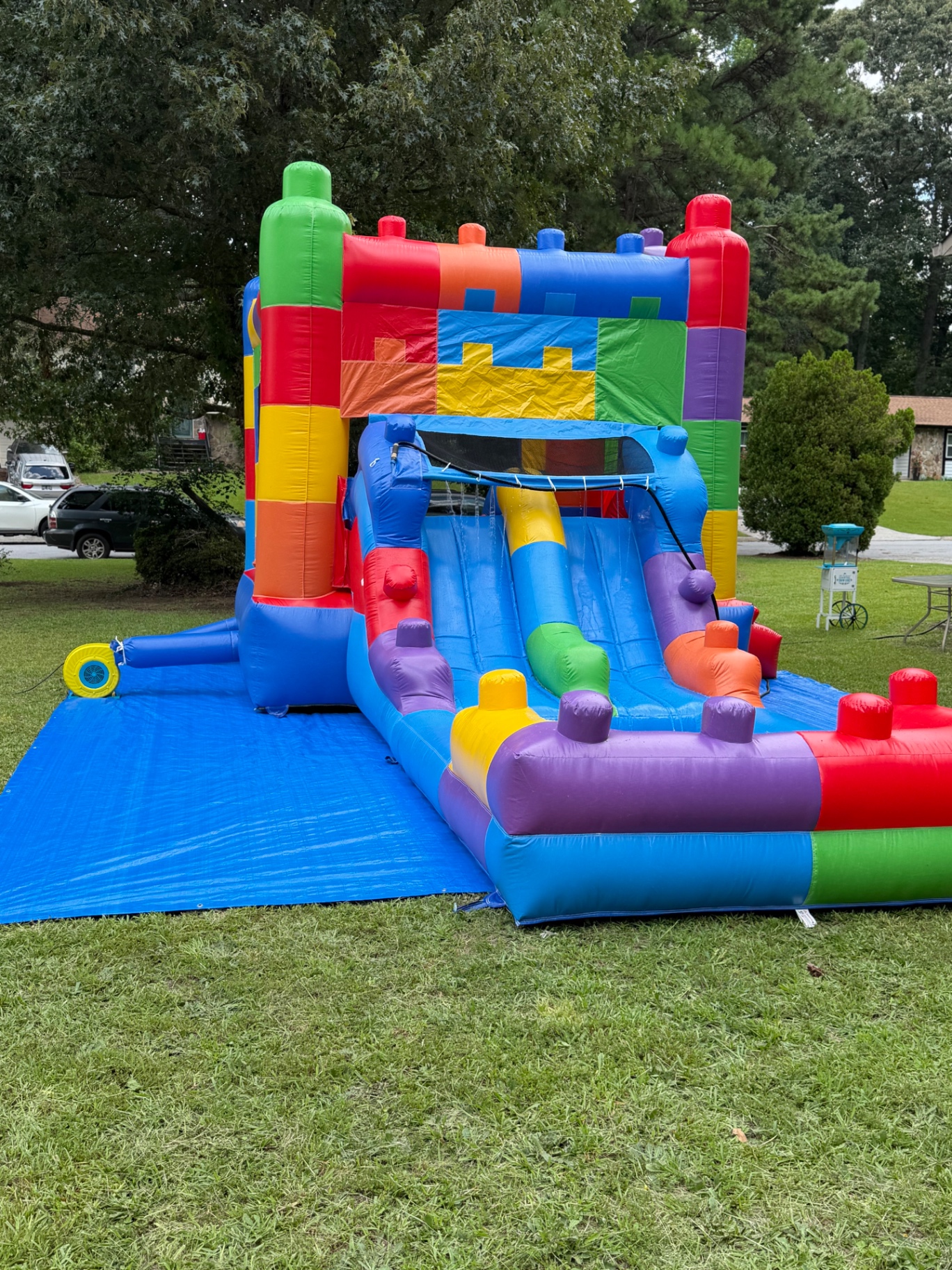 Block-themed bounce house and water slide combo unit