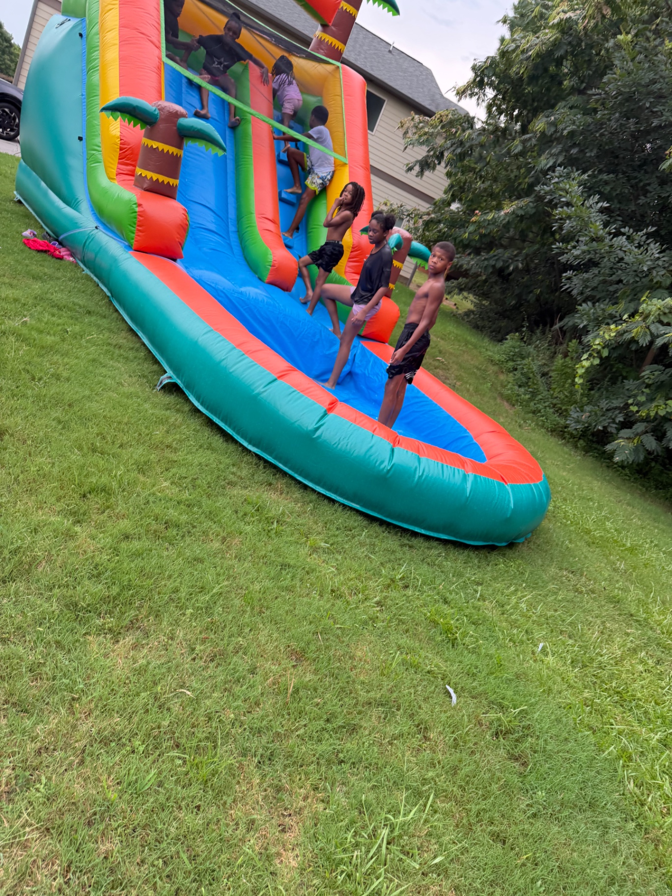 Children playing in the splash pool of a tropical water slide